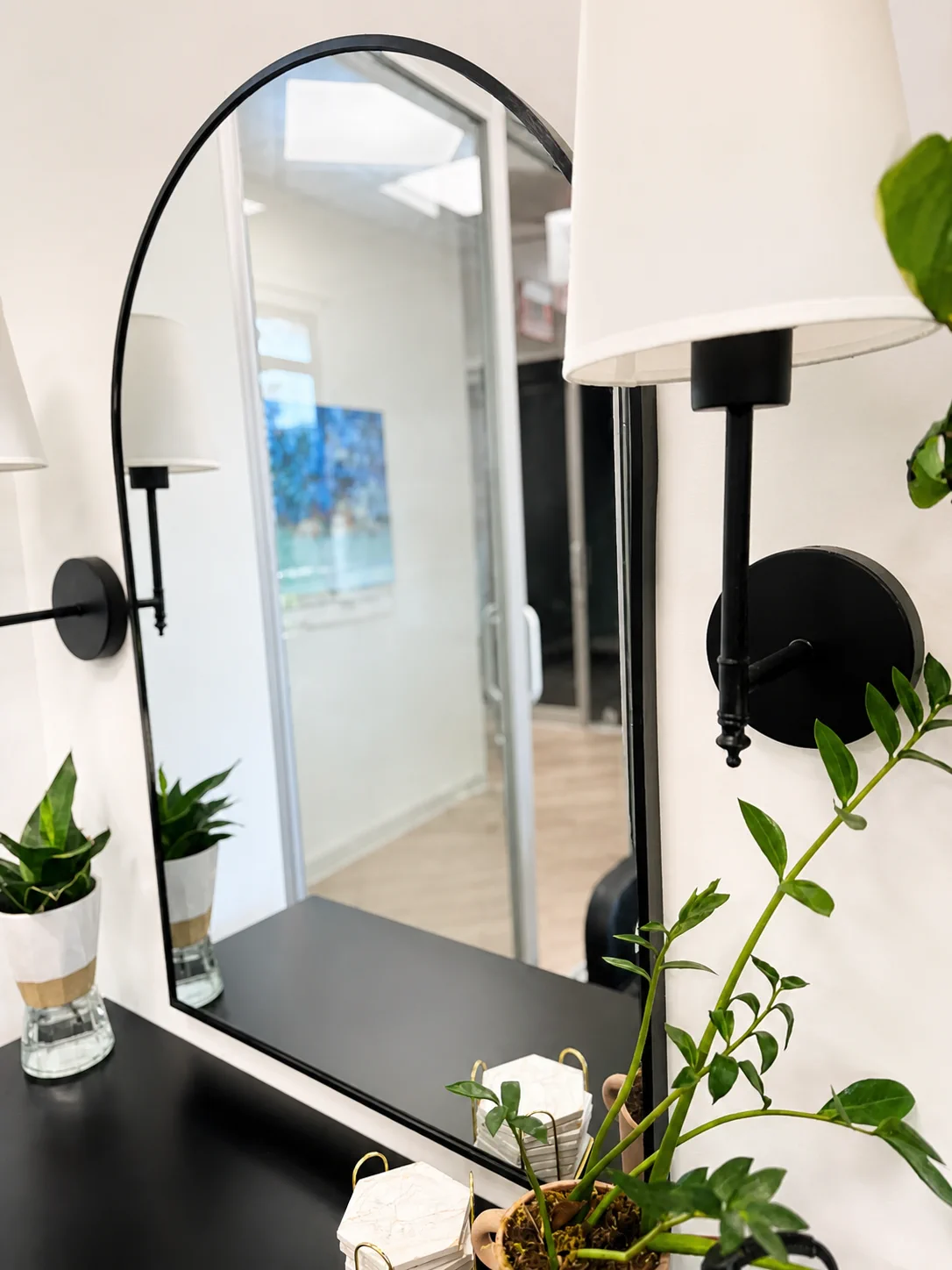 Bright mirror area with plants in Kelly's salon suite